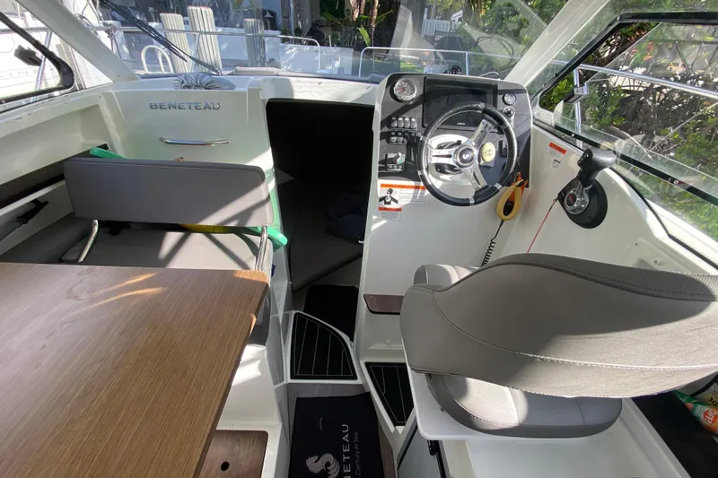 Slide: The Image of Interior of 2022 Beneteau Antares 8 boat, featuring helm and seating area. - 26