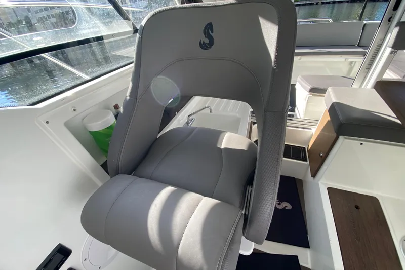 Slide: The Image of Captain's seat in 2022 Beneteau Antares 8 boat, featuring sleek design and comfortable upholstery. - 28