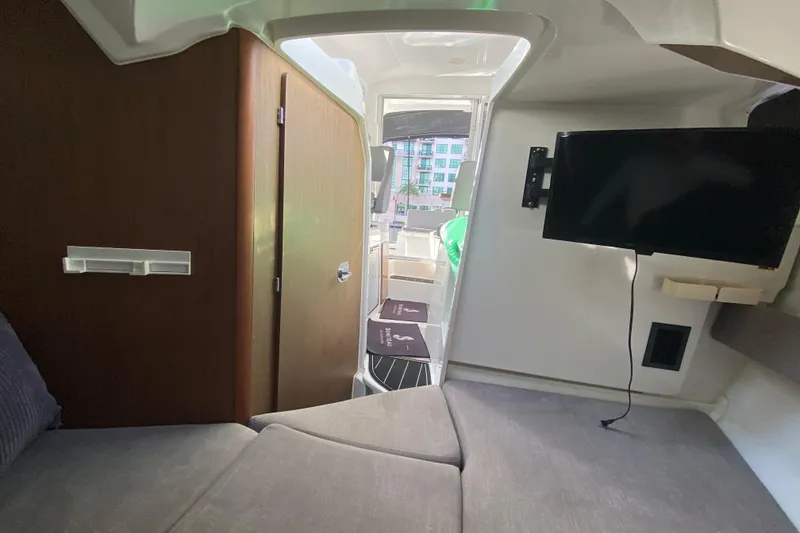 Slide: The Image of Interior of 2022 Beneteau Antares 8 boat with TV and seating area. - 30