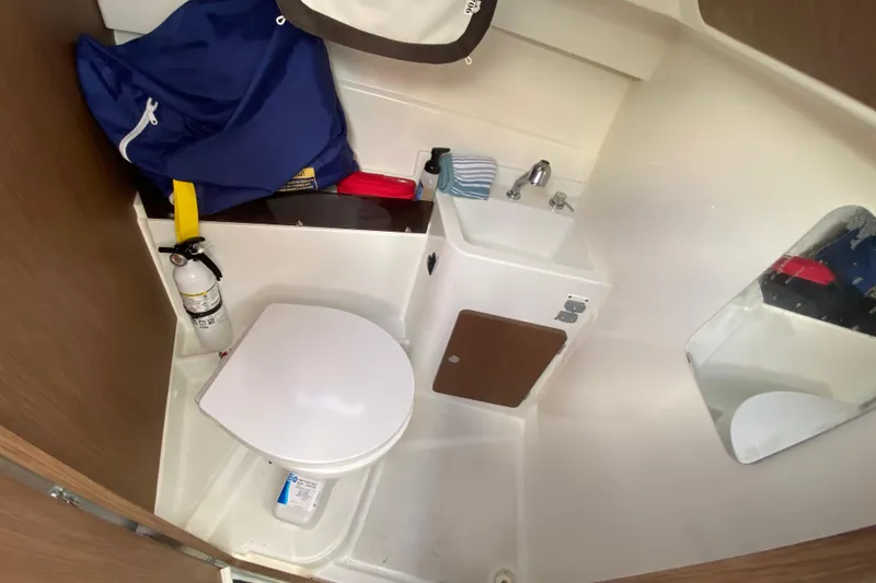 Slide: The Image of Beneteau Antares 8 2022 boat bathroom with toilet, sink, and mirror. - 31