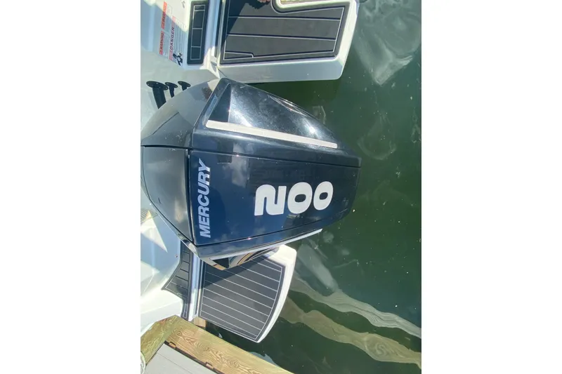 Slide: The Image of Mercury outboard motor on 2022 Beneteau Antares 8 boat, docked in water. - 34