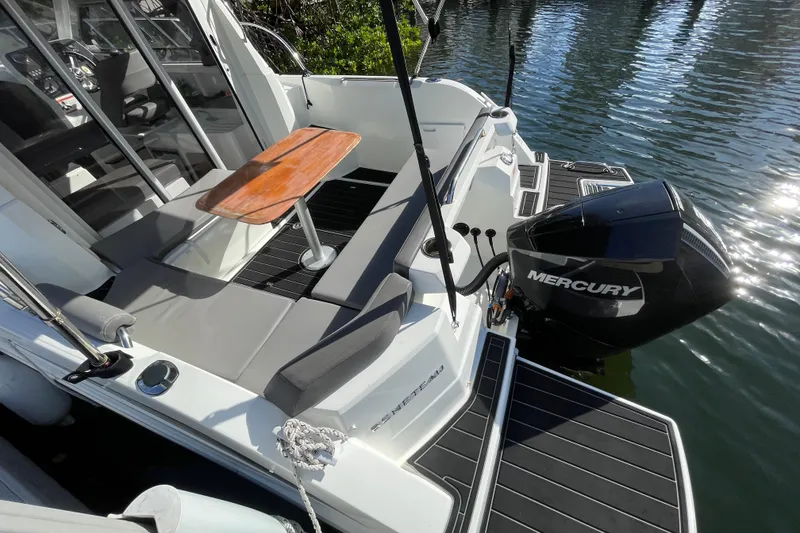 Slide: The Image of 2022 Beneteau Antares 8 boat with Mercury engine, featuring a sleek deck and seating area. - 36
