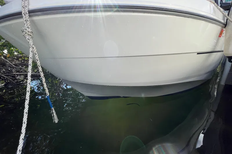 Slide: The Image of Beneteau Antares 8 boat, 2022 model, docked on calm water. - 38