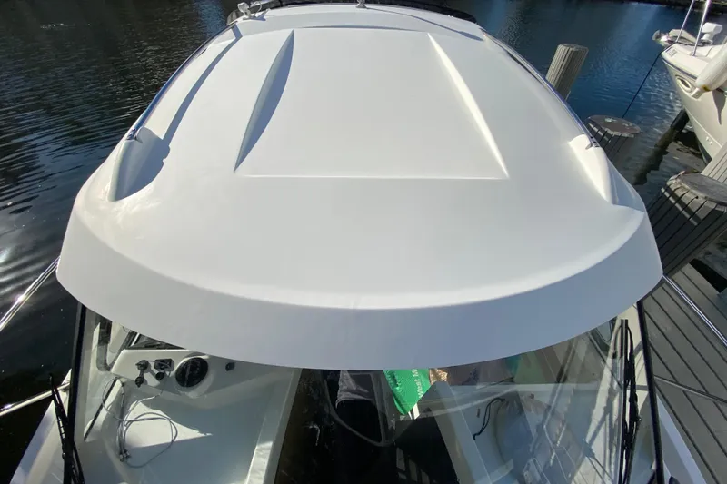 Slide: The Image of 2022 Beneteau Antares 8 boat roof, docked on calm water. - 42