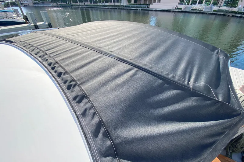 Slide: The Image of Beneteau Antares 8 (2022) boat cover, docked by a calm waterfront. - 43