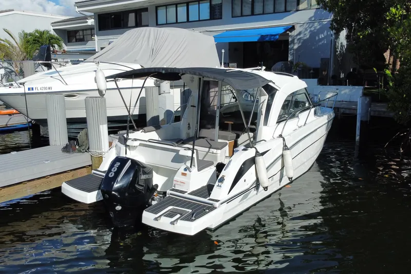Slide: The Image of 2022 Beneteau Antares 8 docked, featuring sleek design and modern outboard motor. - 51