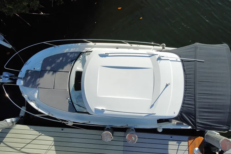 Slide: The Image of Overhead view of 2022 Beneteau Antares 8 docked, showcasing sleek design and spacious deck. - 54