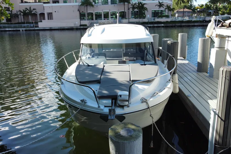 Slide: The Image of 2022 Beneteau Antares 8 docked by waterfront buildings. - 7