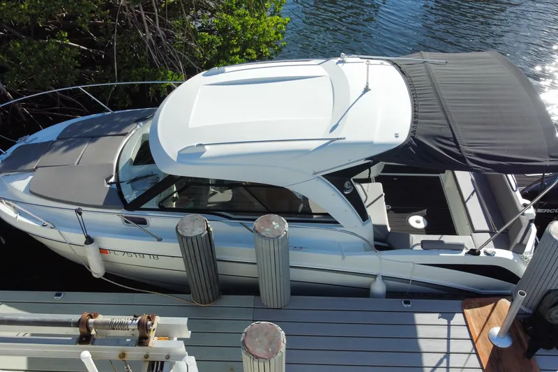 Slide: The Image of 2022 Beneteau Antares 8 docked by a waterfront, showcasing sleek design and modern features. - 9