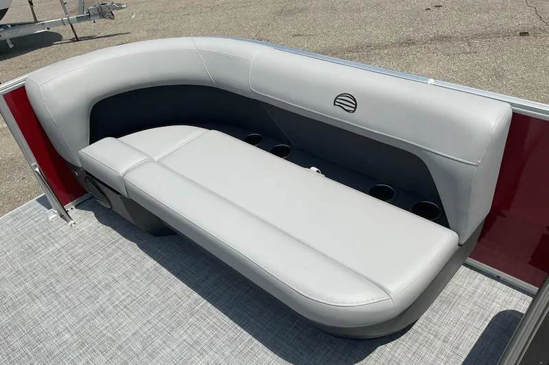 Slide: The Image of 2026 Sun Tracker Party Barge 16 DLX, featuring sleek gray seating and cup holders. - 12