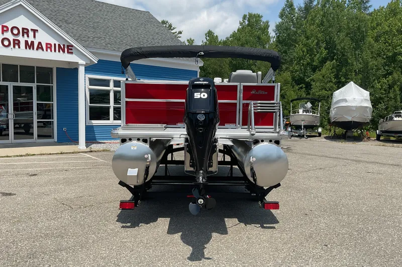 Slide: The Image of 2026 Sun Tracker Party Barge 16 DLX pontoon boat at a marine dealership. - 4