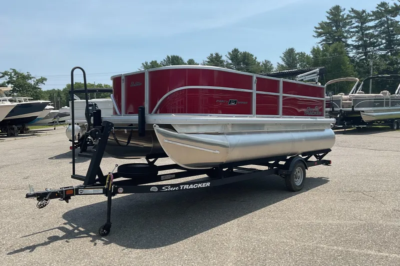 Slide: The Image of 2026 Sun Tracker Party Barge 16 DLX pontoon boat on trailer in outdoor lot. - 7