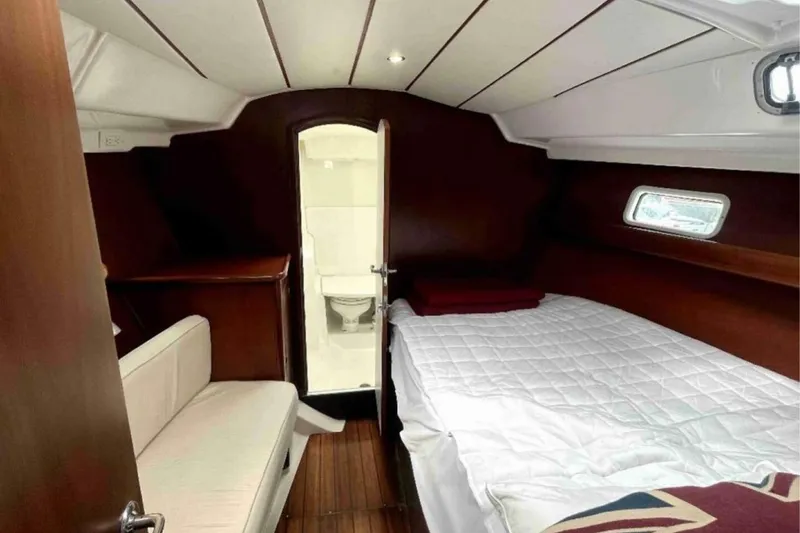 Slide: The Image of Interior cabin of 2001 Beneteau Oceanis 411 sailboat, featuring bed and seating area. - 11