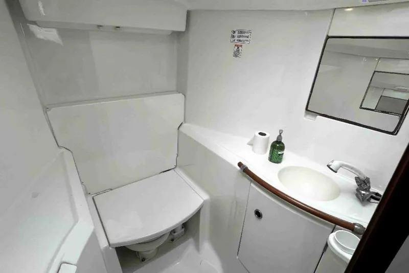 Slide: The Image of Bathroom of 2001 Beneteau Oceanis 411 yacht with sink, mirror, and toilet. - 12