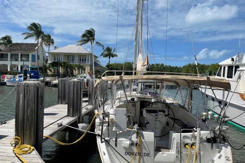 Slide: The Image of Sailboats docked at marina during sunset, featuring a 2001 Beneteau Oceanis 411. - 2