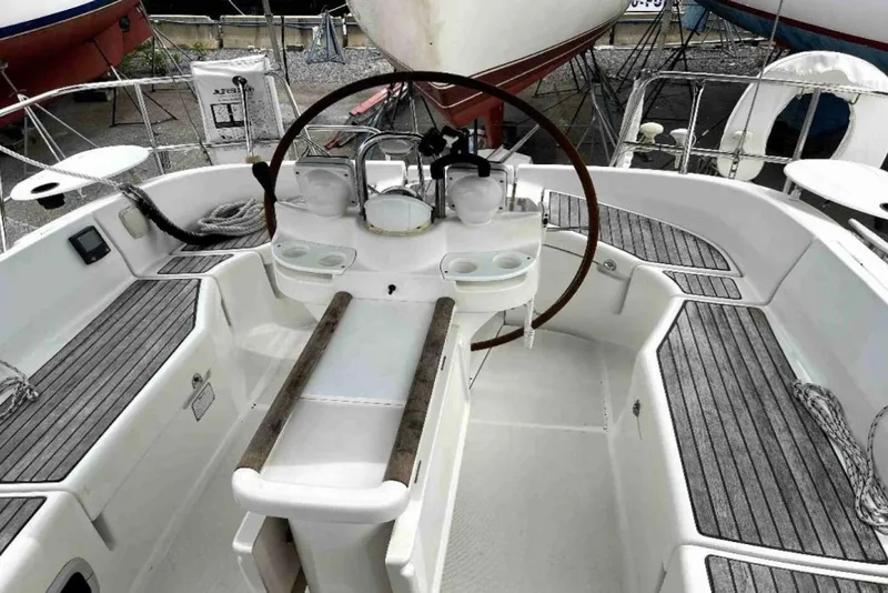 Slide: The Image of 2001 Beneteau Oceanis 411 docked at marina, surrounded by palm trees and waterfront homes. - 3