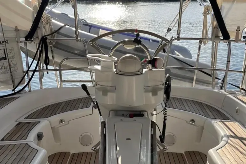 Slide: The Image of 2001 Beneteau Oceanis 411 sailboat cockpit with wooden accents and steering wheel. - 4