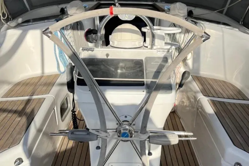 Slide: The Image of Cockpit of 2001 Beneteau Oceanis 411 sailboat with steering wheel and wooden deck. - 5