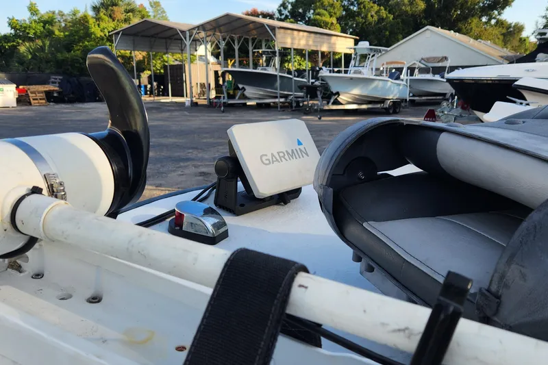 Slide: The Image of 1997 Polar 1700 Skiff with Garmin device, parked in a boatyard. - 11