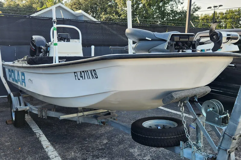Slide: The Image of 1997 Polar 1700 Skiff boat on trailer, parked outdoors. - 12