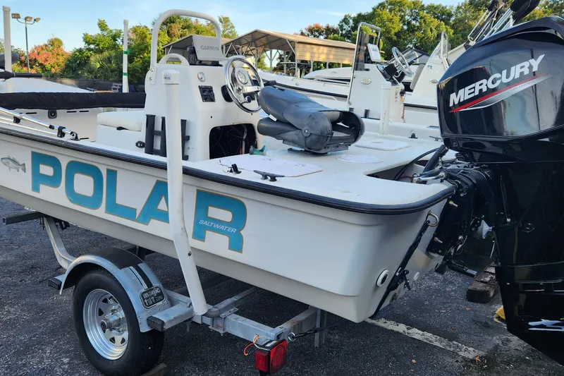 Slide: The Image of 1997 Polar 1700 Skiff boat with Mercury engine on trailer, parked outdoors. - 15