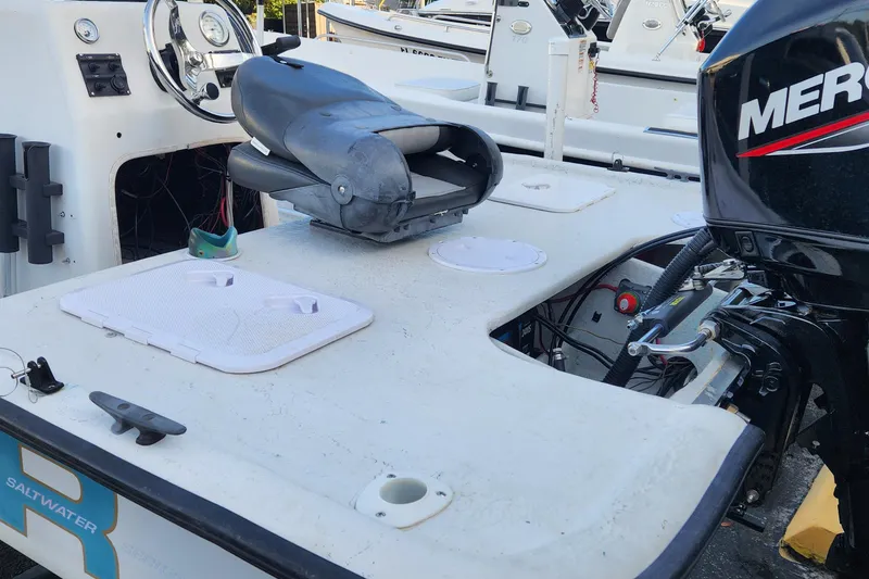 Slide: The Image of 1997 Polar 1700 Skiff boat with Mercury outboard motor, featuring a spacious deck and seating. - 4