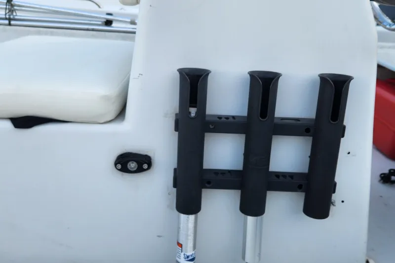 Slide: The Image of 1997 Polar 1700 Skiff boat with rod holders and white seating. - 7