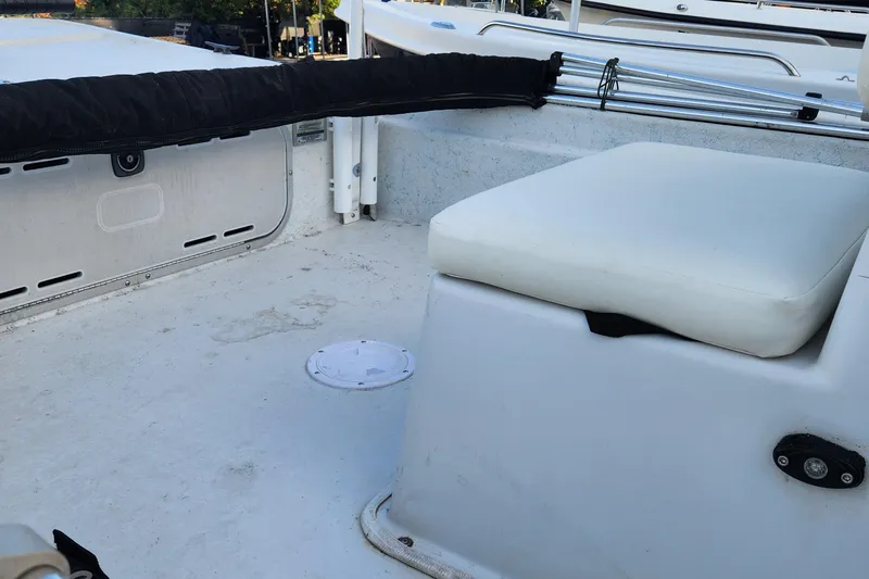 Slide: The Image of 1997 Polar 1700 Skiff boat interior with cushioned seating and storage area. - 8