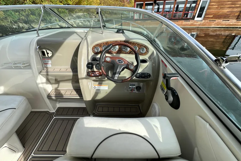 Slide: The Image of 2007 Sea Ray 225 Weekender boat cockpit with steering wheel and controls. - 10