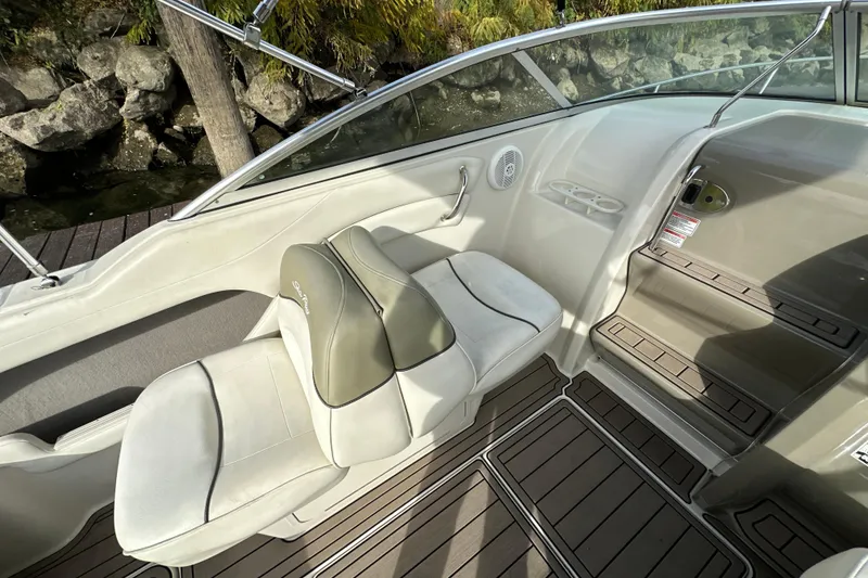 Slide: The Image of 2007 Sea Ray 225 Weekender boat interior with seating and steps, featuring sleek design elements. - 12