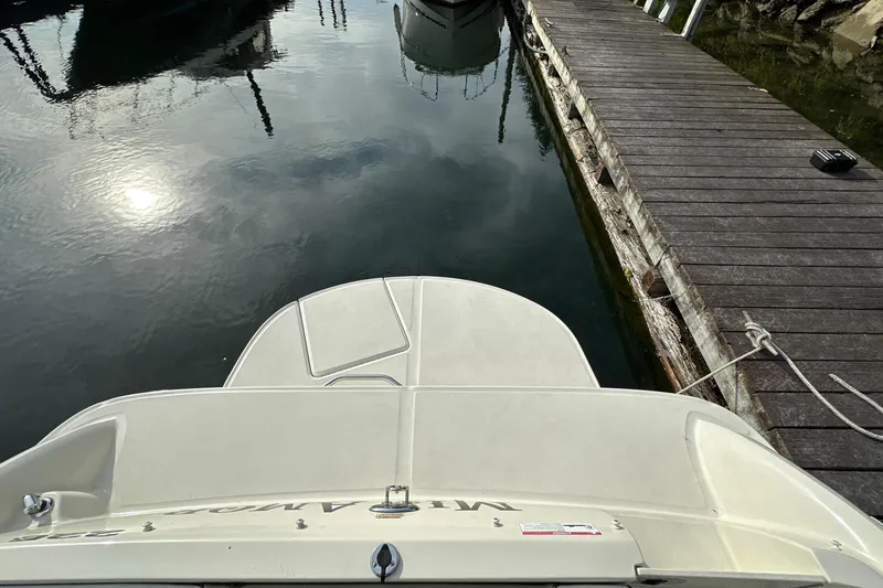 Slide: The Image of 2007 Sea Ray 225 Weekender docked at a marina, viewed from above. - 16