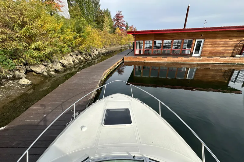 Slide: The Image of Bow of 2007 Sea Ray 225 Weekender near dock and wooden building. - 17