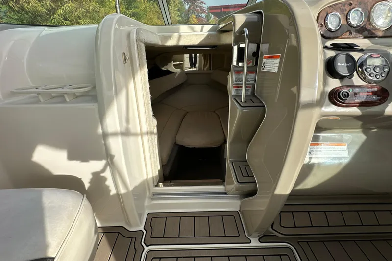 Slide: The Image of 2007 Sea Ray 225 Weekender cabin interior with dashboard and seating area. - 18