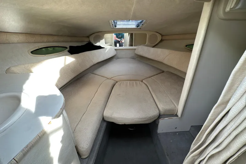 Slide: The Image of Interior cabin of 2007 Sea Ray 225 Weekender boat, featuring cozy seating and natural light. - 19