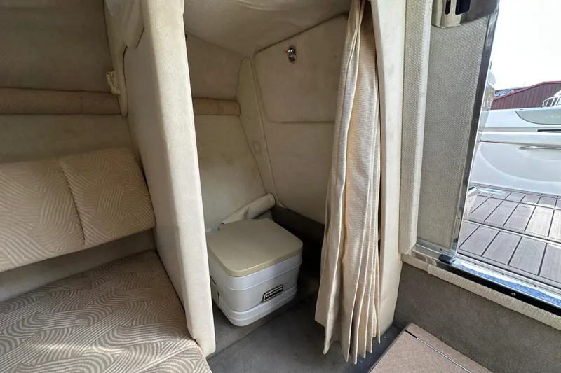 Slide: The Image of Interior cabin of 2007 Sea Ray 225 Weekender with portable toilet and seating area. - 20