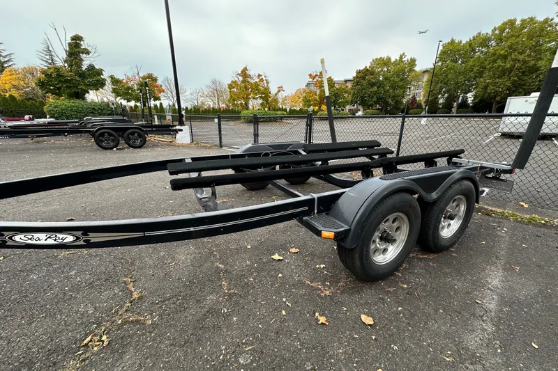 Slide: The Image of Trailer for 2007 Sea Ray 225 Weekender in parking lot, surrounded by autumn trees. - 28