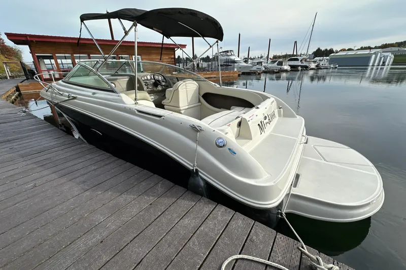 Slide: The Image of 2007 Sea Ray 225 Weekender boat docked at marina, featuring sleek design and spacious interior. - 4