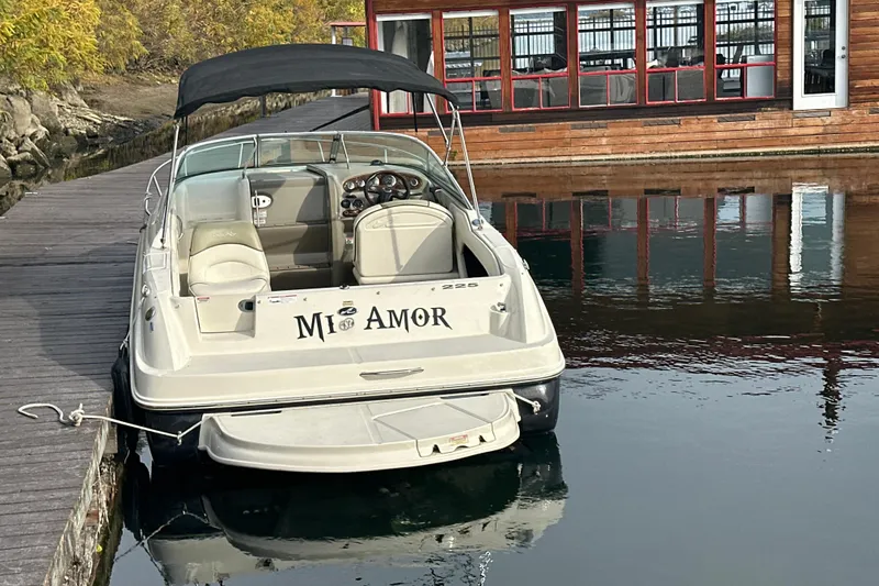Slide: The Image of 2007 Sea Ray 225 Weekender boat docked near a wooden building. - 5
