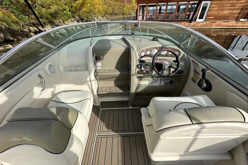 Slide: The Image of 2007 Sea Ray 225 Weekender boat interior with steering wheel and seating. - 9