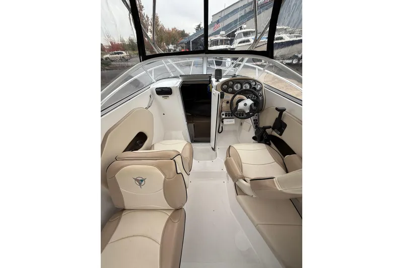 Slide: The Image of 2006 Campion Explorer 602i Sport Cabin interior with beige seating and control panel. - 12