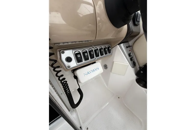 Slide: The Image of 2006 Campion Explorer 602i Sport Cabin dashboard with control panel and Navman device. - 14