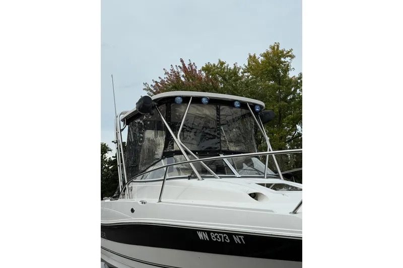 Slide: The Image of 2006 Campion Explorer 602i Sport Cabin boat with sleek design and protective canopy. - 18