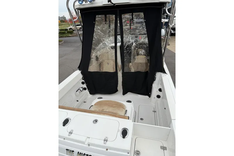 Slide: The Image of 2006 Campion Explorer 602i Sport Cabin boat interior with black curtains and seating. - 8