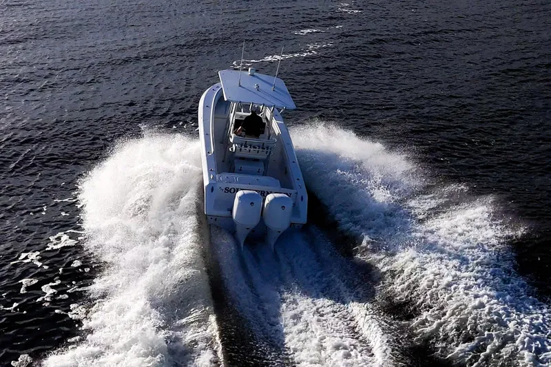 Slide: The Image of 2005 Jupiter 27 boat cruising on open water, creating dynamic wake patterns. - 11