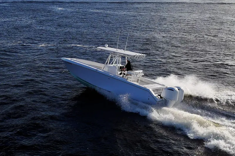 Slide: The Image of 2005 Jupiter 27 boat cruising on open water, creating waves. - 14