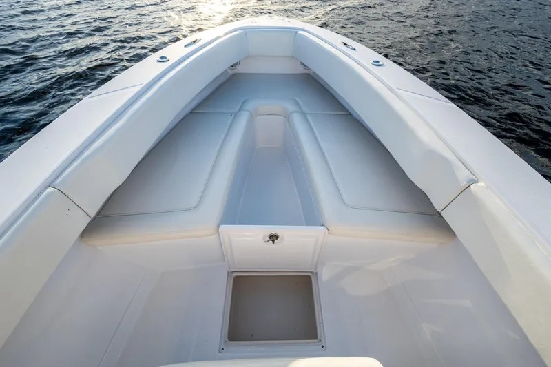 Slide: The Image of Bow seating area of a 2005 Jupiter 27 boat on water. - 17
