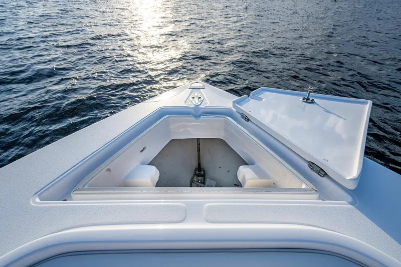 Slide: The Image of Bow of 2005 Jupiter 27 boat with open storage compartment on water. - 18