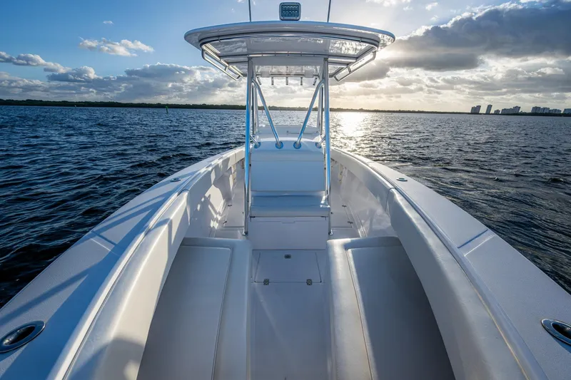 Slide: The Image of 2005 Jupiter 27 boat on water at sunset, showcasing sleek design and spacious deck. - 20