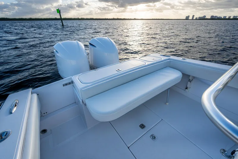 Slide: The Image of 2005 Jupiter 27 boat interior with dual engines, on calm water at sunset. - 23