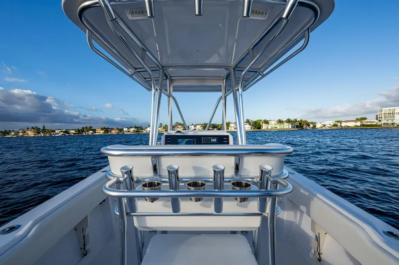 Slide: The Image of 2005 Jupiter 27 boat on water, clear sky, coastal view, stainless steel rod holders. - 25